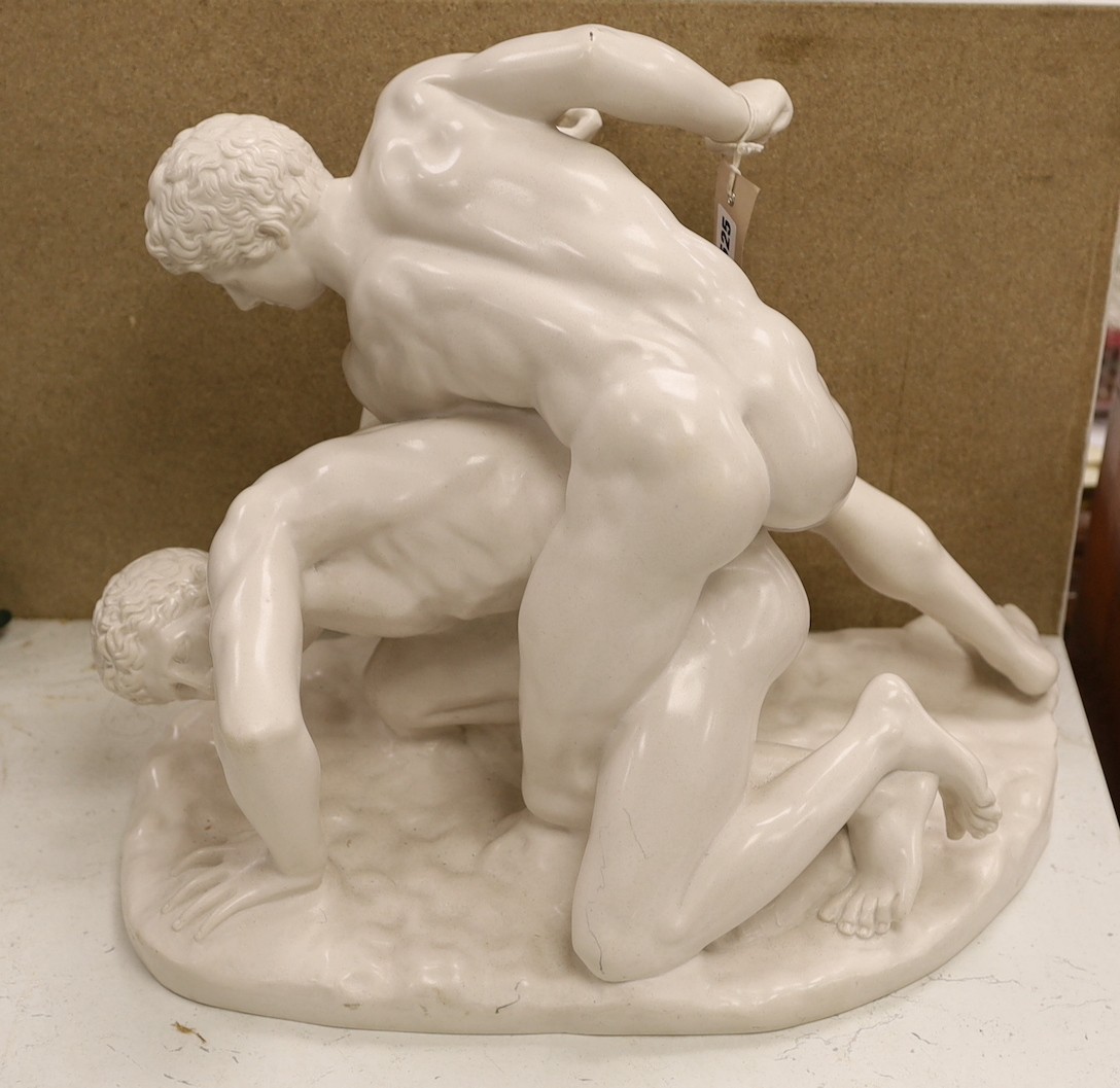 A composite figure group modelled as two wrestling men, ‘sculptured arts studio’, ‘SAS’ and ‘made in England’ stamped to base. 39 cms high